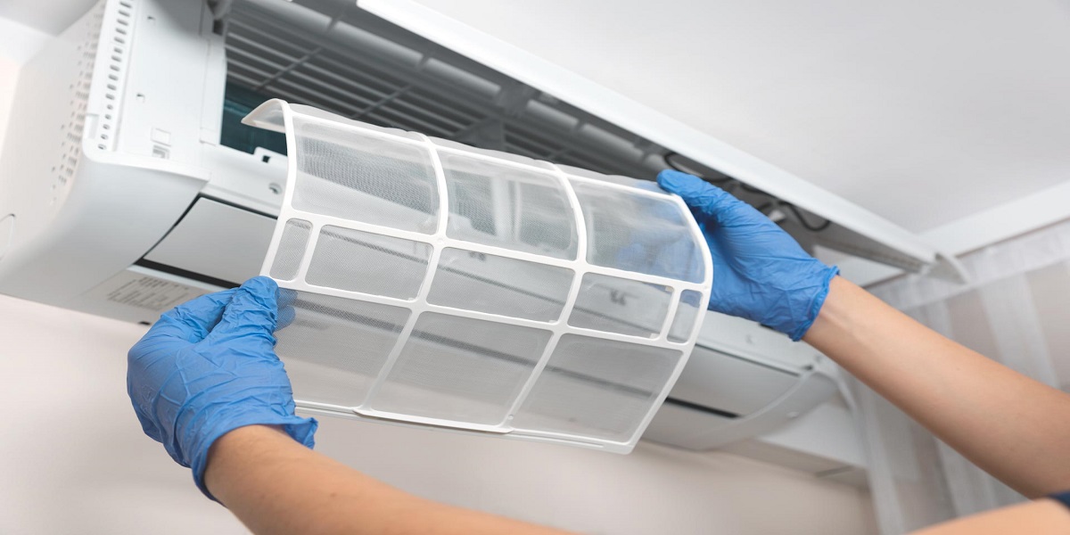 Engineer servicing air conditioning equipment